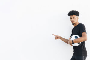 black-man-with-soccer-ball-pointing-with-finger